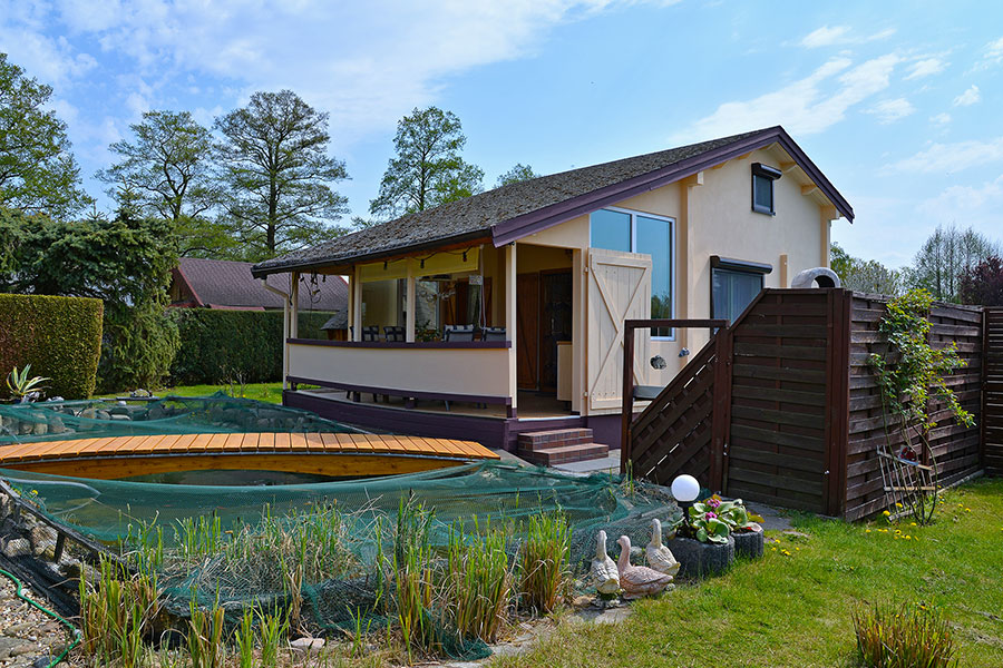 Ferienhaus, Außenansicht mit Terrasse und Teich – Copyright: K. Wiesner